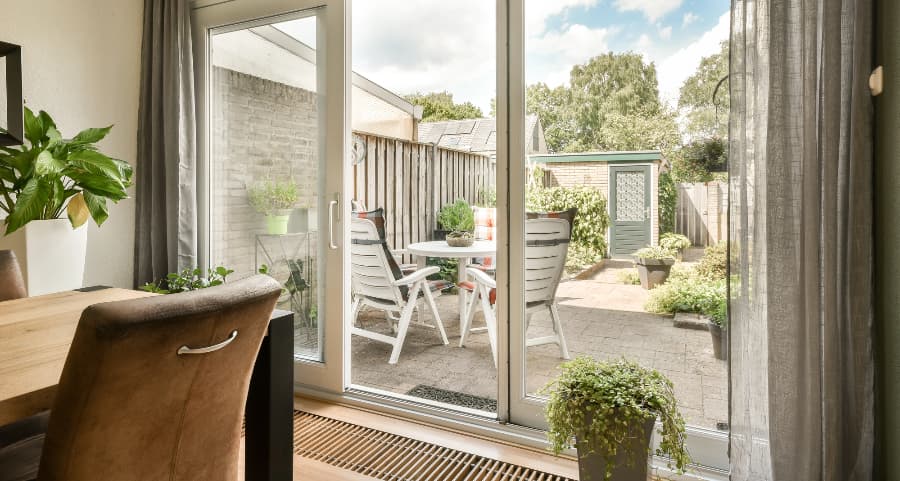 Sliding glass door offering easy access to a paver patio